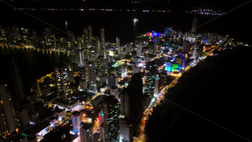 Video - Aerial drone view showing Cartagena's glittering skyline along the Caribbean coast at night