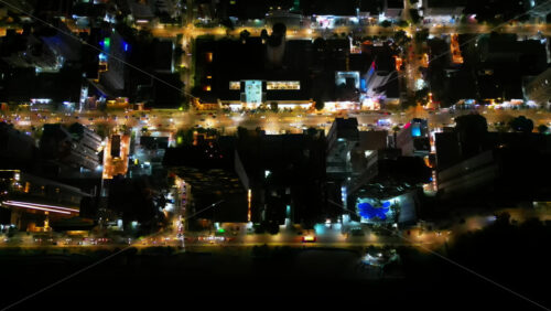 Video - Aerial drone view of Cartagena's city streets illuminated at night, filled with traffic and urban activity