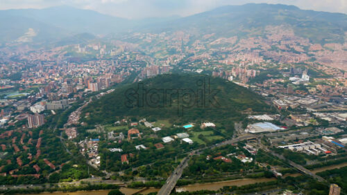 Video - Aerial drone view of Medellin, Colombia, showing the dense urban skyline surrounded by mountains