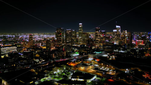 Video - Aerial drone view of heavy traffic moving through Los Angeles highways at night