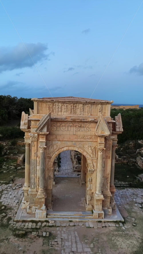 Video - Aerial drone view of the magnificent Arch of Septimius Severus in Leptis Magna, Libya. Vertical