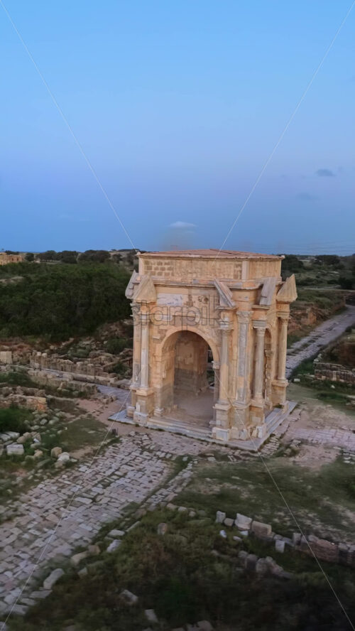 Video - Aerial drone view of the magnificent Arch of Septimius Severus in Leptis Magna, Libya. Vertical