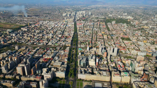 Video - Aerial drone view of central Santiago showcasing government buildings, parks, and a grid of city streets bathed in sunlight