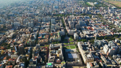 Video - Aerial drone view of the organized grid and high rise skyline of central Santiago under clear daylight