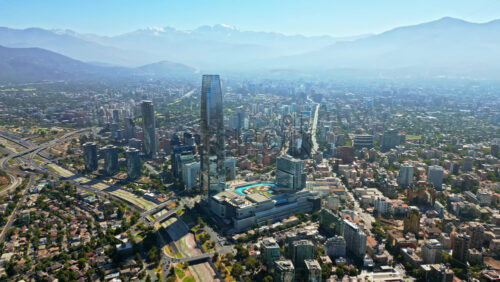 Video - Aerial drone view of the Costanera Center skyscraper rising above the city with the Andes mountains visible in the distance