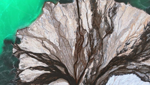 Video – Aerial drone view a mineral lake with bright turquoise water meeting textured white sediment - Starpik Stock