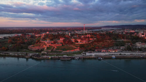 Video – Aerial drone view of Kalemegdan Fortress and Park in Belgrade, Serbia, illuminated by warm sunset light - Starpik Stock