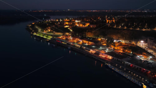 Video – Aerial drone view of Kalemegdan Fortress illuminated in warm lights at night - Starpik Stock