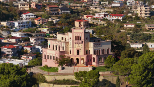 Video – Aerial drone view of King Zog’s Villa palace sitting on a hill overlooking the Durres, Albania - Starpik Stock