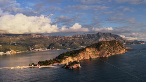 Video – Aerial drone view of Mogren or Slovenska Plaza area, showing a rocky peninsula jutting into the sea. Montenegro - Starpik Stock