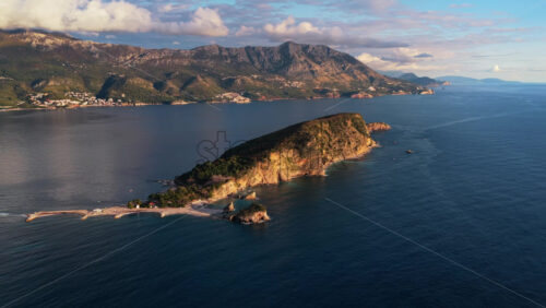 Video – Aerial drone view of Mogren or Slovenska Plaza area, showing a rocky peninsula jutting into the sea. Montenegro - Starpik Stock
