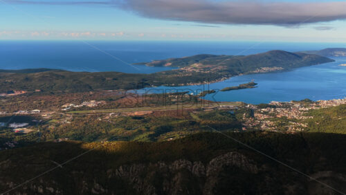 Video – Aerial drone view of Montenegro’s coastline, open sea, mountains, and the Tivat airport runway from above - Starpik Stock