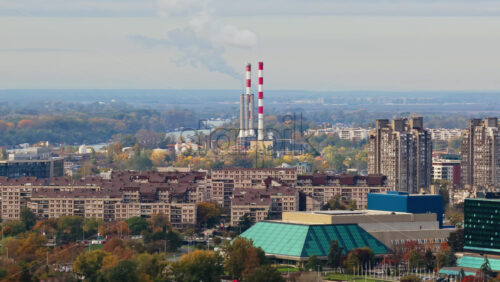 Video – Aerial drone view of Novi Beograd, Serbia, highlighting large residential block buildings and the distinctive chimneys of the Novi Beograd heating plant in the distance - Starpik Stock