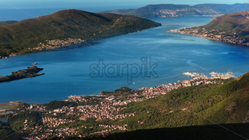 Video – Aerial drone view of Tivat Bay, with the coastline, islands, and marinas clearly visible under bright morning sunlight - Starpik Stock