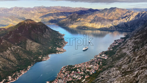 Video – Aerial drone view of Tivat Bay, with the coastline, islands, and marinas clearly visible under bright morning sunlight - Starpik Stock