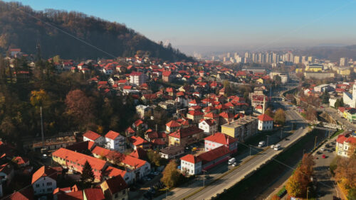 Video – Aerial drone view of Tuzla’s hillside neighborhoods with traditional homes and red rooftops, blending into the broader city skyline - Starpik Stock