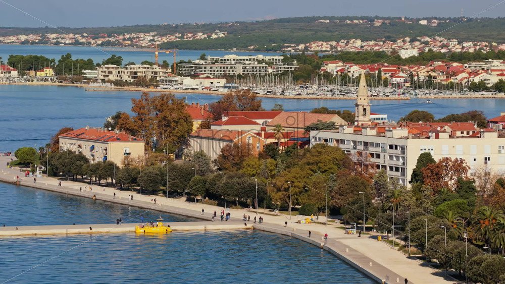 Video – Aerial drone view of Zadar’s seafront promenade with people walking along the Adriatic shoreline - Starpik Stock