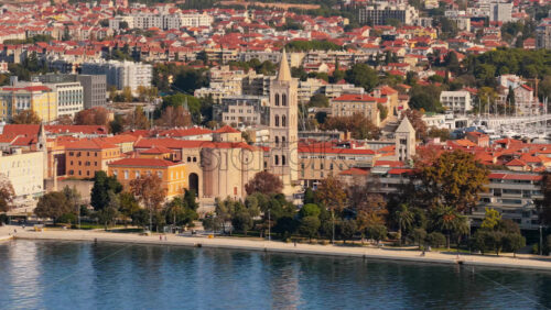 Video – Aerial drone view of Zadar’s waterfront and historic Old Town, with St. Anastasia Cathedral’s bell tower prominently visible - Starpik Stock