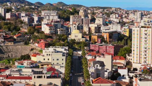 Video – Aerial drone view of a long, straight boulevard lined with tall palm trees in Durres, Albania - Starpik Stock