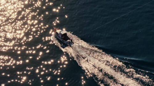 Video – Aerial drone view of a small motorboat speeding across the water, leaving a white foamy trail behind it on the calm turquoise sea. Biograd na Moru, Croatia - Starpik Stock