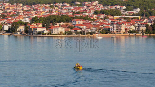 Video – Aerial drone view of a small yellow tourist semi submarine boat cruising across the Zadar Channel - Starpik Stock