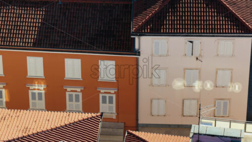 Video – Aerial drone view of colorful Mediterranean style buildings with orange and yellow facades, white shutters, and terracotta roofs. Zadar, Croatia - Starpik Stock