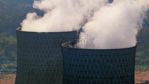 Video – Aerial drone view of large cooling towers releasing white steam at the Tuzla Power Plant - Starpik Stock