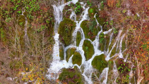 Video – Aerial drone view of multiple terraced lakes surrounded by dense, leafless autumn forests at Plitvice Lakes National Park, Croatia - Starpik Stock