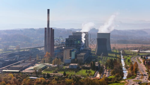 Video – Aerial drone view of several large cooling towers releasing steam into the air at the Tuzla Power Plant - Starpik Stock