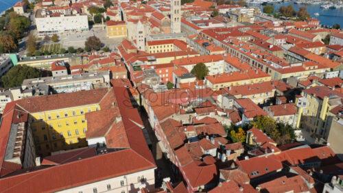 Video – Aerial drone view of the compact structure of Zadar Old Town with tightly arranged terracotta rooftops, stone houses, old courtyards, and narrow medieval streets - Starpik Stock