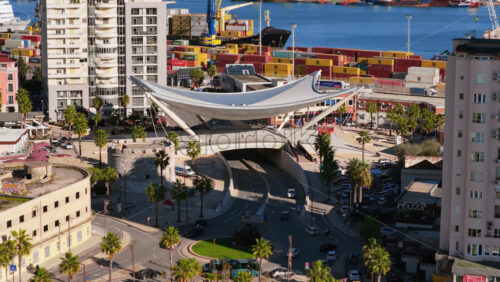 Video – Aerial drone view of the futuristic white, sail shaped pedestrian and vehicular overpass near the port in Durres, Albania - Starpik Stock