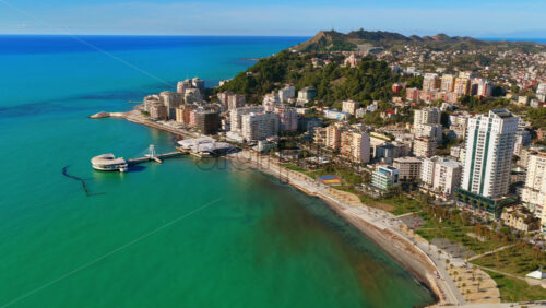 Video – Aerial drone view of the iconic circular Rotonda building extending over the turquoise waters of the Adriatic Sea in Durres, Albania - Starpik Stock