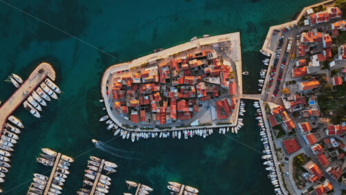 Video – Aerial drone view of the old town of Tribunj, Croatia, featuring tightly packed stone houses on island - Starpik Stock