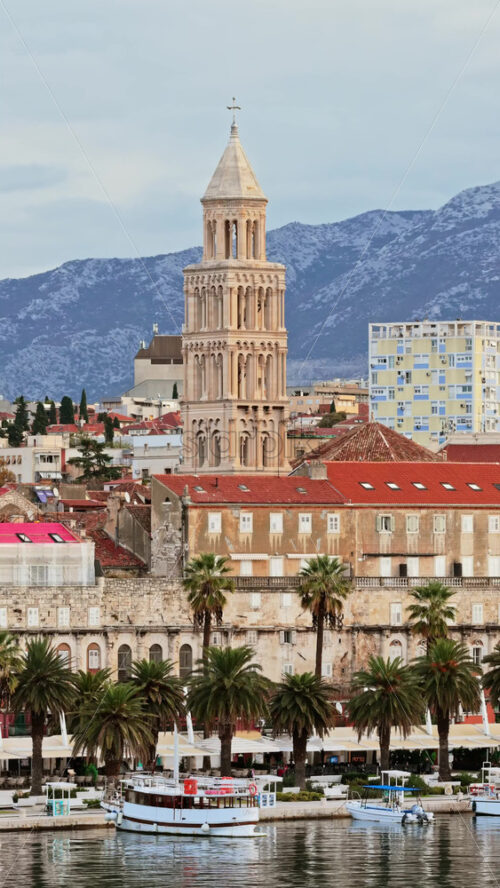 Video – Aerial drone view of the tall bell tower of St. Anastasia Cathedral rising above Zadar’s red roofed historic center. Vertical - Starpik Stock
