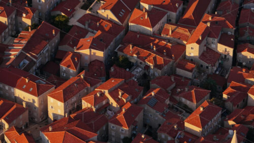 Video – Aerial drone view of the warm toned stone rooftops and narrow streets of Budva’s Old Town. Montenegro - Starpik Stock