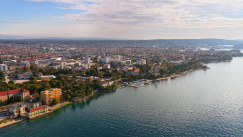 Video – Aerial drone view of the wider Zadar urban area residential districts, modern buildings, coastline neighborhoods, and the Adriatic shoreline - Starpik Stock