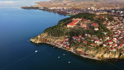 Video – Aerial drone view the entire Kaneo peninsula, the Church of St. John, lush forests, and the surrounding coastline of Ohrid - Starpik Stock
