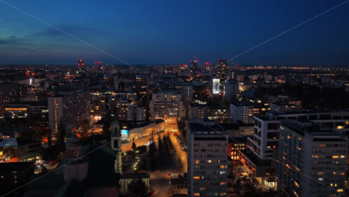 Video – Warsaw, Poland – October 30, 2025: Aerial drone view of Warsaw’s residential districts illuminated at night with the skyline visible in the distance - Starpik Stock