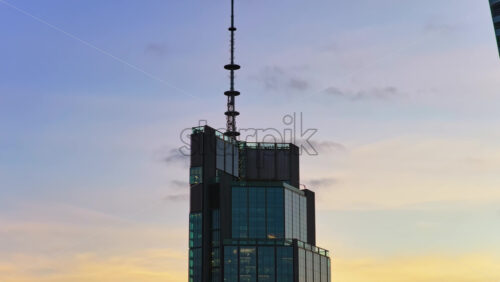 Video – Warsaw, Poland – October 30, 2025: Aerial drone view of the Warsaw Trade Tower featuring its rooftop antenna, set against an overcast evening sky in Warsaw’s Wola district - Starpik Stock