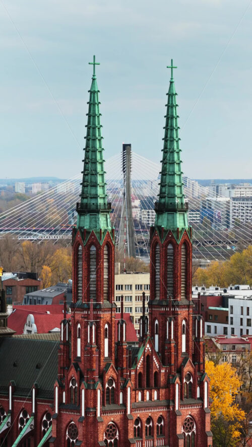 Video – Warsaw, Poland – October 31, 2025: Aerial drone view of the facade of St. Florian Cathedral in Praga, featuring its brickwork and symmetrical Gothic design. Vertical - Starpik Stock