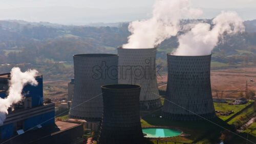 Video - Aerial drone view of several large cooling towers releasing steam into the air at the Tuzla Power Plant