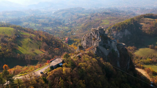 Video - Aerial drone view of Srebrenik Fortress, a medieval stronghold perched dramatically atop a steep rock cliff in Bosnia and Herzegovina