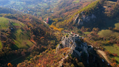Video - Aerial drone view of Srebrenik Fortress, a medieval stronghold perched dramatically atop a steep rock cliff in Bosnia and Herzegovina