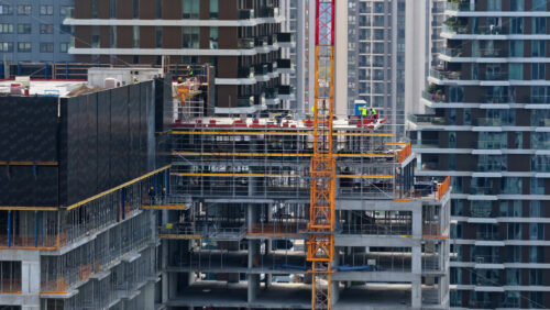Video - Aerial drone view of construction workers on a high rise building in the Belgrade Waterfront district