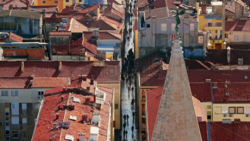 Video - Aerial drone view of Zadar's famous Kalelarga Street, filled with people walking along the polished stone pedestrian avenue