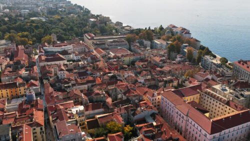 Video - Aerial drone view of the dense Old Town layout with terracotta roofs leading towards the sea. Zadar, Croatia