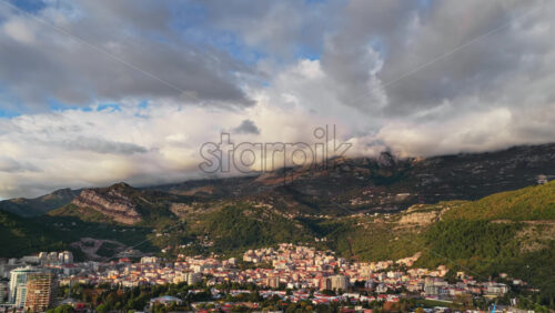 Video - Aerial drone view of Budva Old Town nestled at the base of dramatic peaks. Montenegro