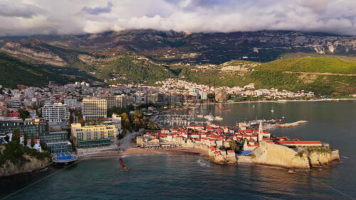 Video - Aerial drone view over Budva, capturing the coastline, the marina, and the Old Town. Montenegro