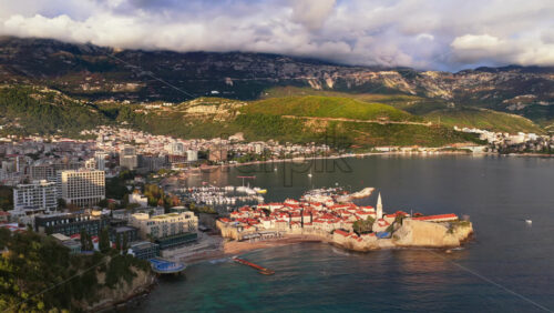Video - Aerial drone view over Budva, capturing the coastline, the marina, and the Old Town. Montenegro