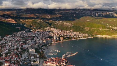 Video - Aerial drone view over Budva, capturing the coastline, the marina, and the Old Town. Montenegro